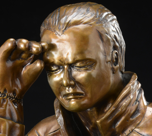 Memorial bronze sculpture of a fireman with the expression of suffering after a tragedy