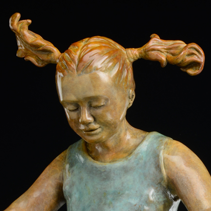 Bronze sculpture young girl with expression of joy in her game of hopscotch